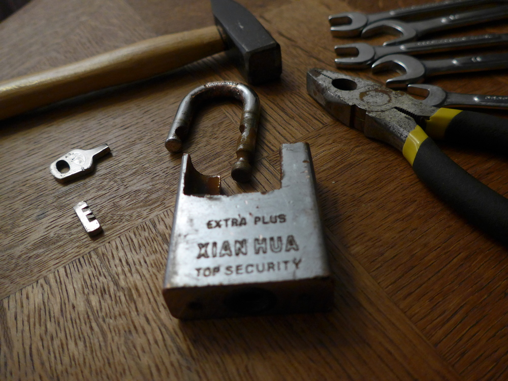 Two weeks later, by sheer serendipity this youtube video showed up in my recommendations. Using a small variation of the method in the video, I was able to force the lock open in about 10 minutes. I used a wrench as a lever supported atop combination pliers and a hammer. In the video some metal part breaks. Here nothing snapped as far as I can tell. I forced the top loop past the play in the bolts.